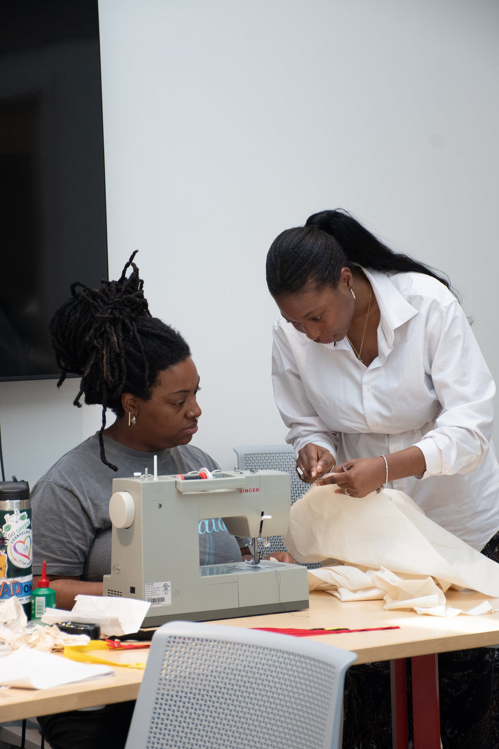 Yele teaching a class , private sewing class