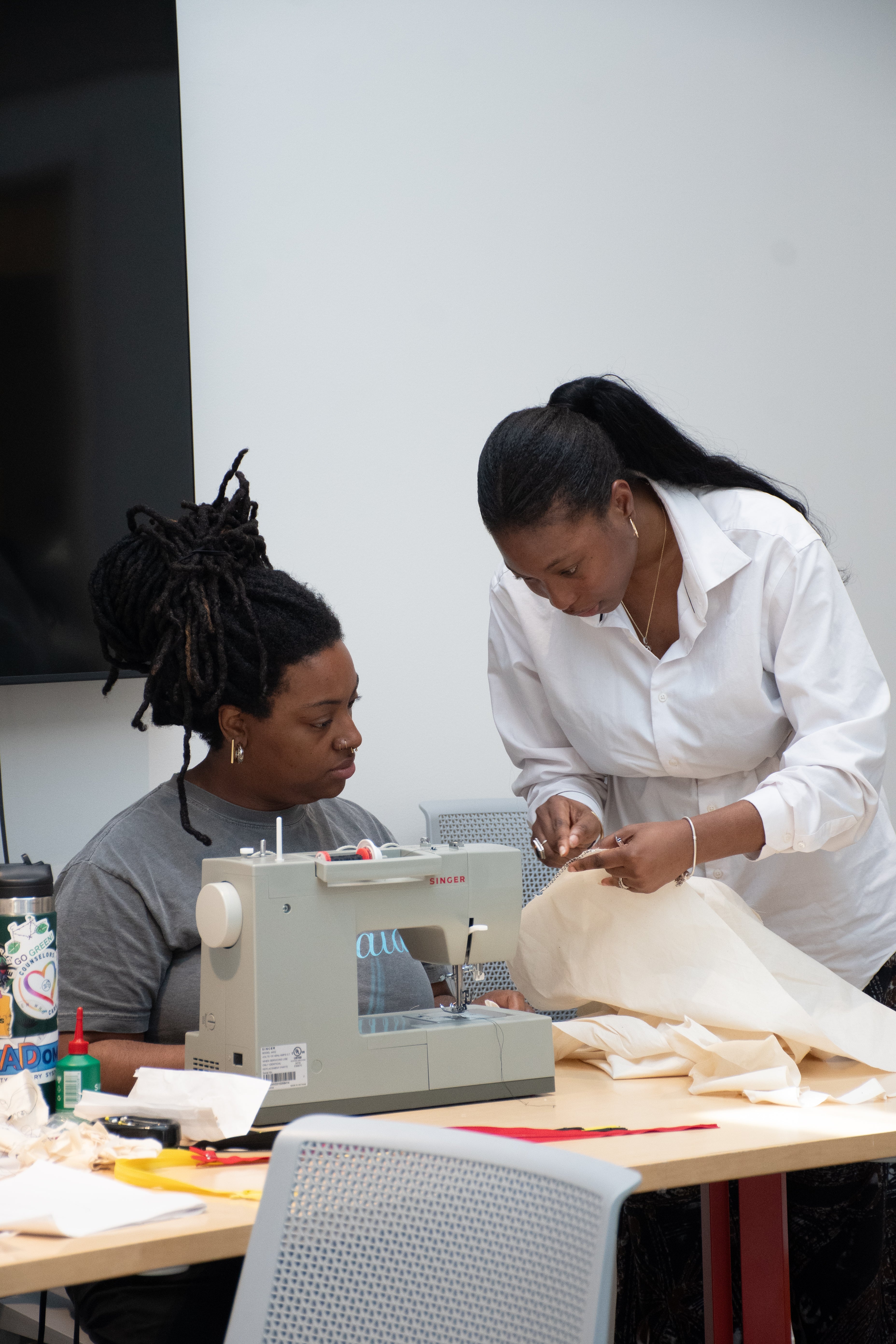 Yele teaching a class , private sewing class