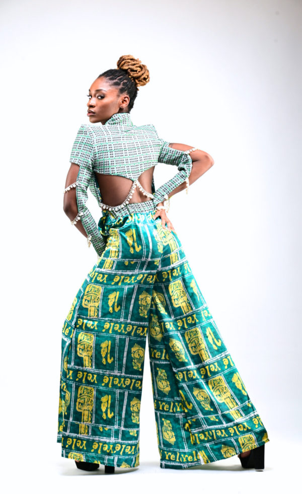 Experience the blend of Afrofuturistic fashion and traditional royal elements in our African Royal Tweed Two-Piece Suit. The tweed jacket is luxuriously lined with green Adire print, signifying royalty and is adorned with pearl rhinestones, while the matching palazzo pants radiate a soft satin finish. It's more than clothing - it's a celebration of African culture and modern style.