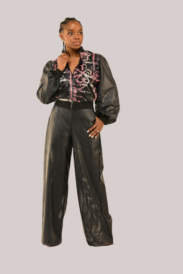 Model in Yele's Open-Back Sequin Bomber Jacket and Vegan Leather Pants with Adire cultural prints