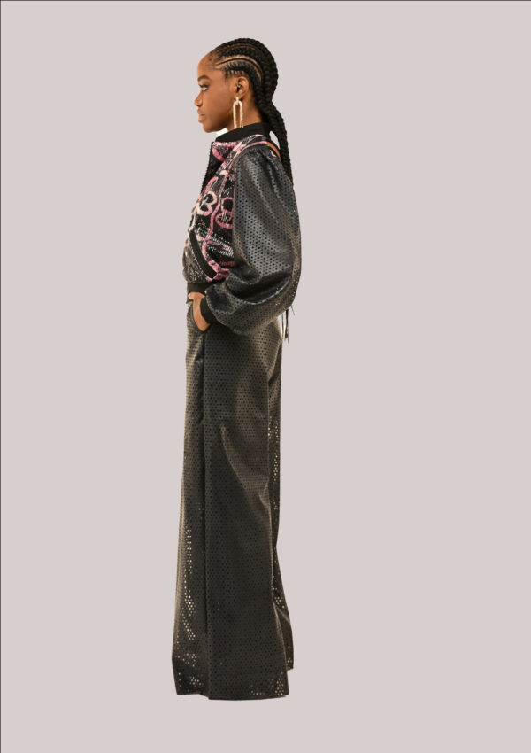 Side view;Model in Yele's Open-Back Sequin Bomber Jacket and Vegan Leather Pants with Adire cultural prints