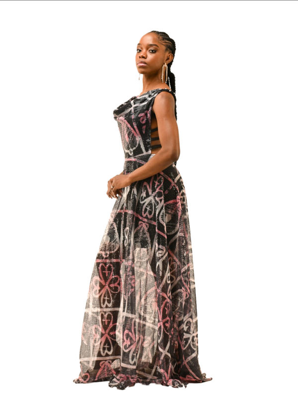 Side profile of a luxurious African print dress, perfect for red carpet events, with a sheer bottom half and cultural motif detailing