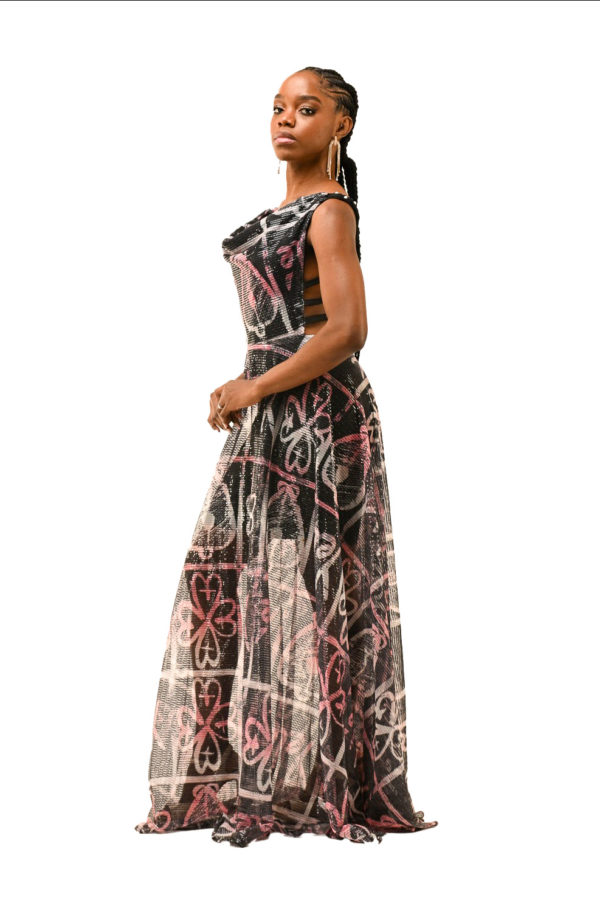 Side profile of a luxurious African print dress, perfect for red carpet events, with a sheer bottom half and cultural motif detailing
