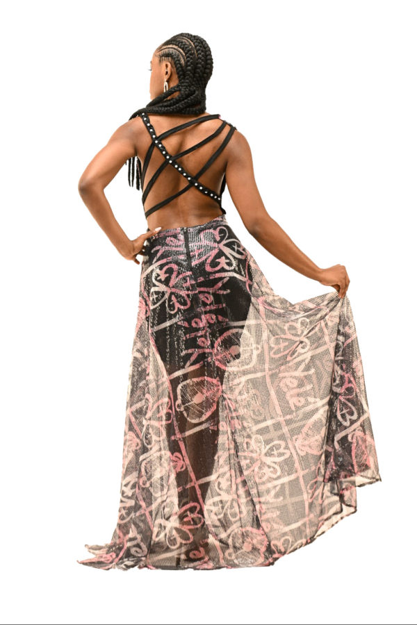Full-length shot of an open-back dress with cowl neck and braids, combining African heritage and modern fashion for a show-stopping appearance