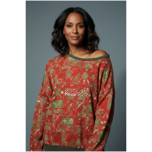 Woman wearing a red and green Festivity Print cotton fleece sweatshirt with cultural celebration symbols.